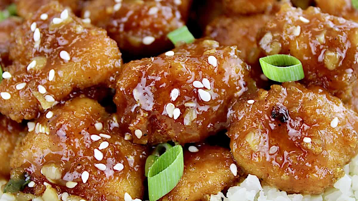 closeup of Keto Orange Chicken with scallions and sesame seeds