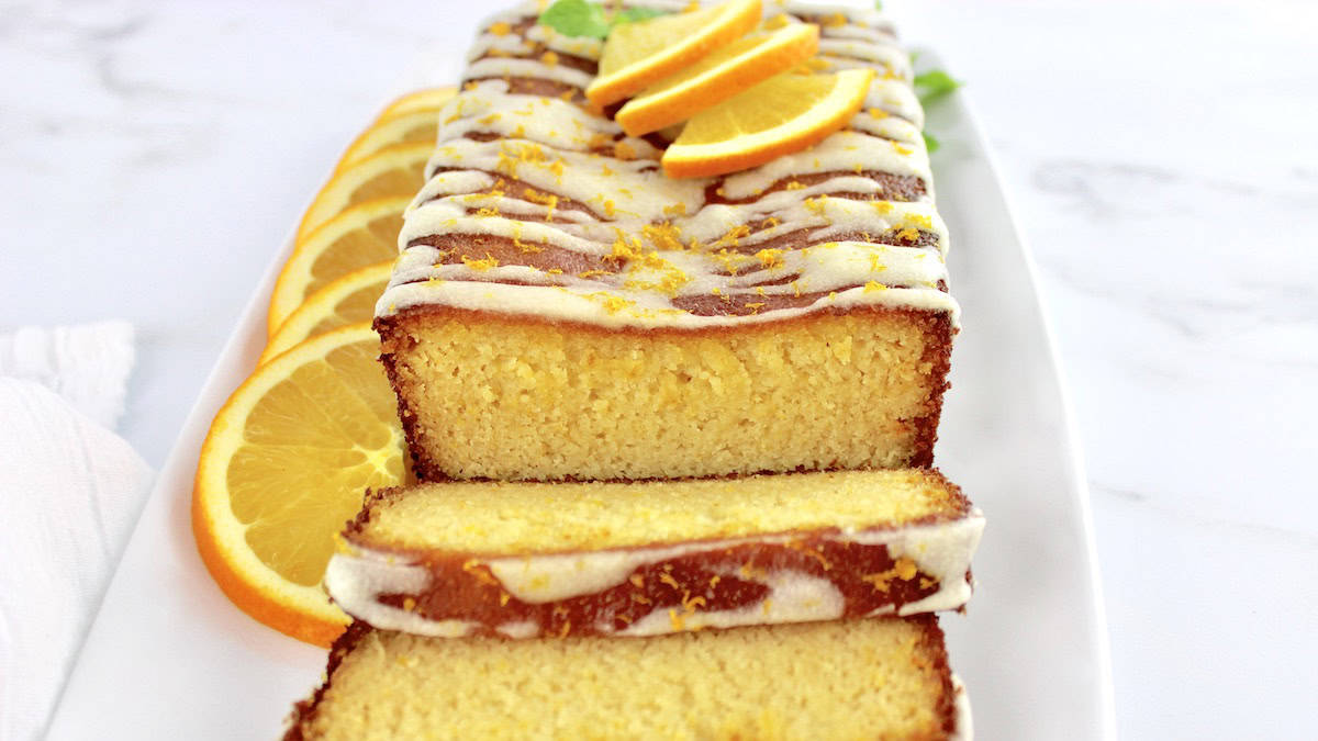 Keto Orange Pound Cake with some slices and icing on top