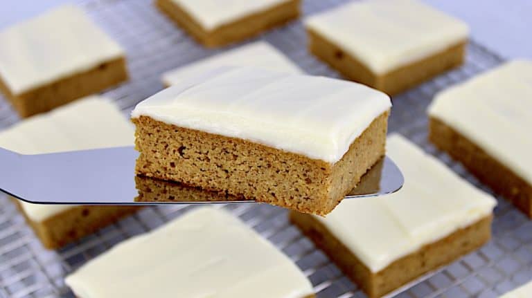 Keto Pumpkin Bar being held up with silver spatula over cooling rack