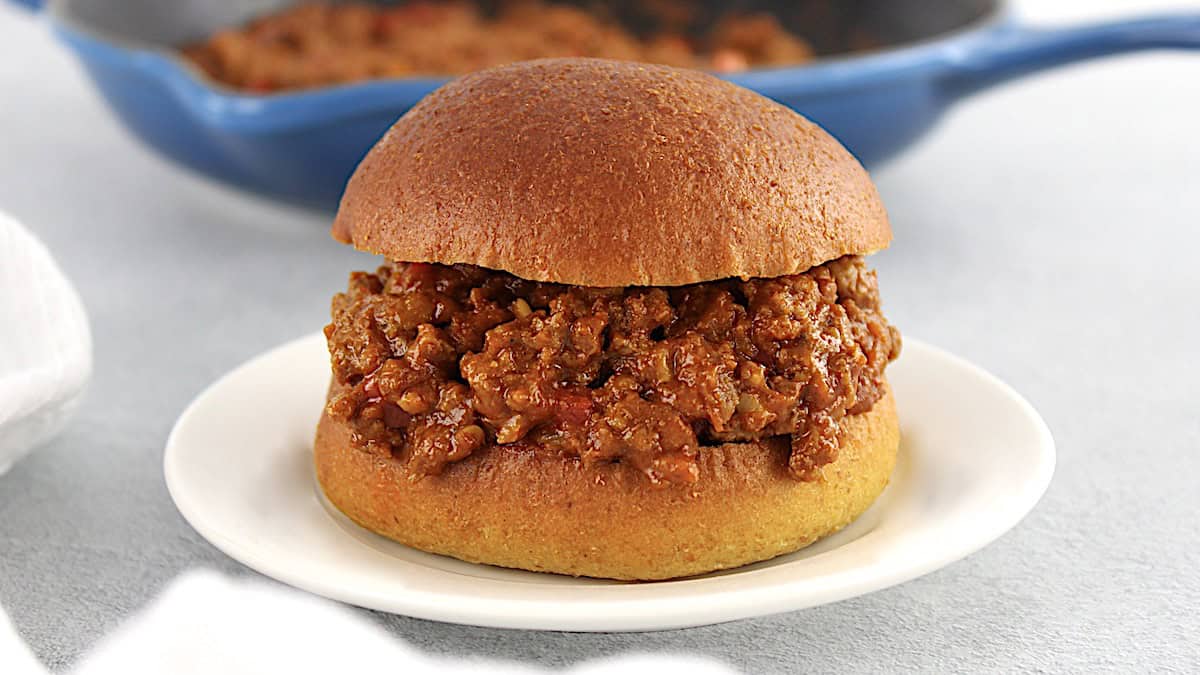 Keto Sloppy Joe on white plate with blue skillet in background