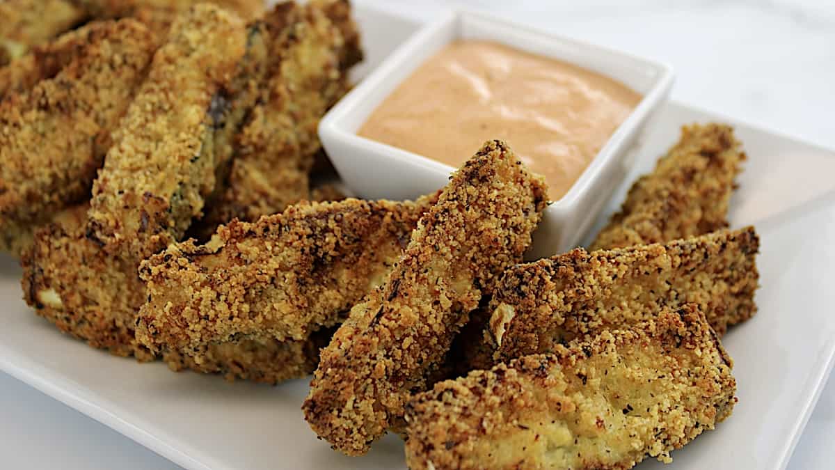 Keto Zucchini Fries on white plated with dipping sauce