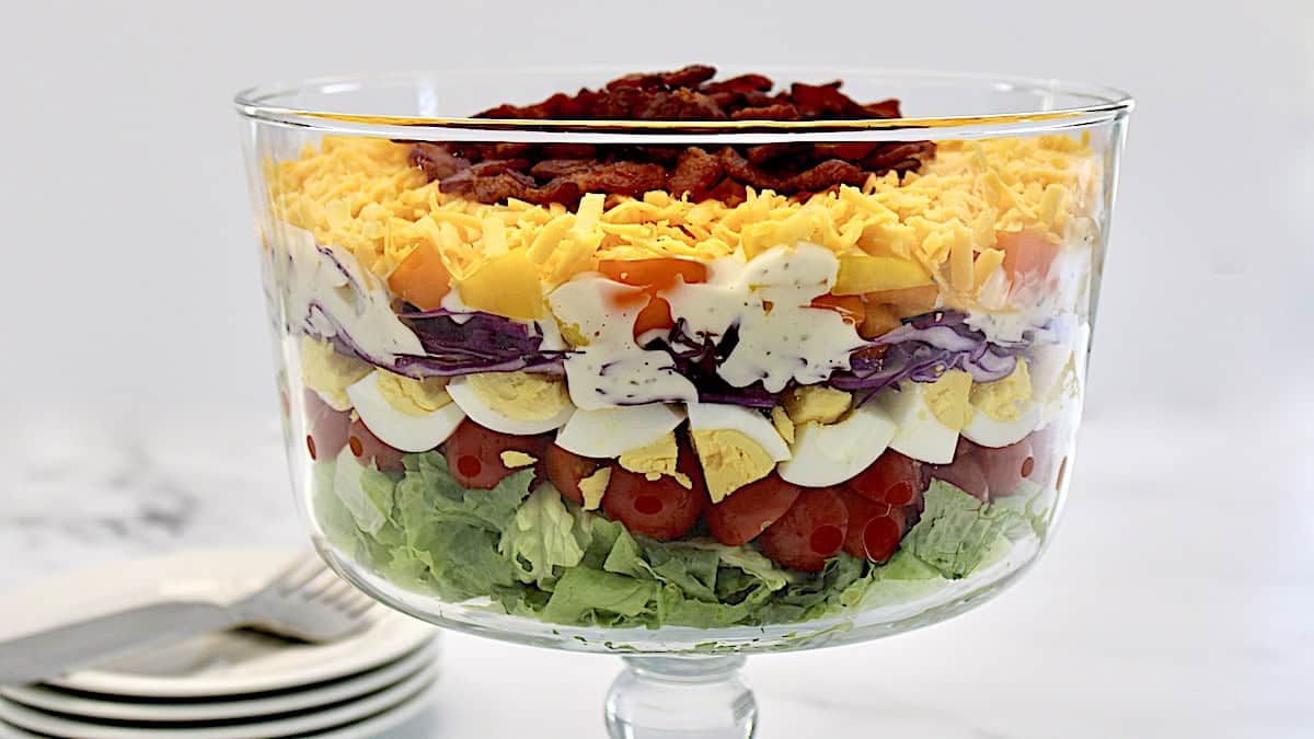 closeup side view of Layered Overnight Salad in parfait glass bowl