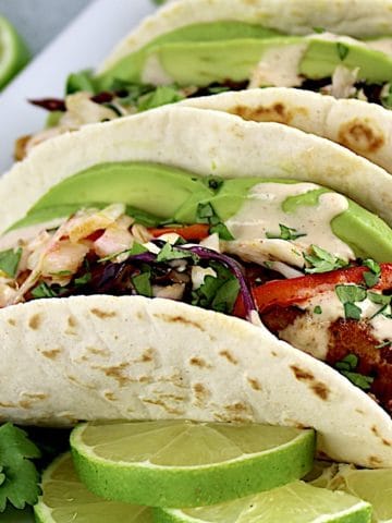 closeup of Mahi Mahi Tacos in white plate