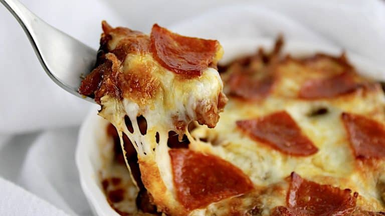 Pizza Bowl with pepperoni and piece lifting out with fork pulling the cheese