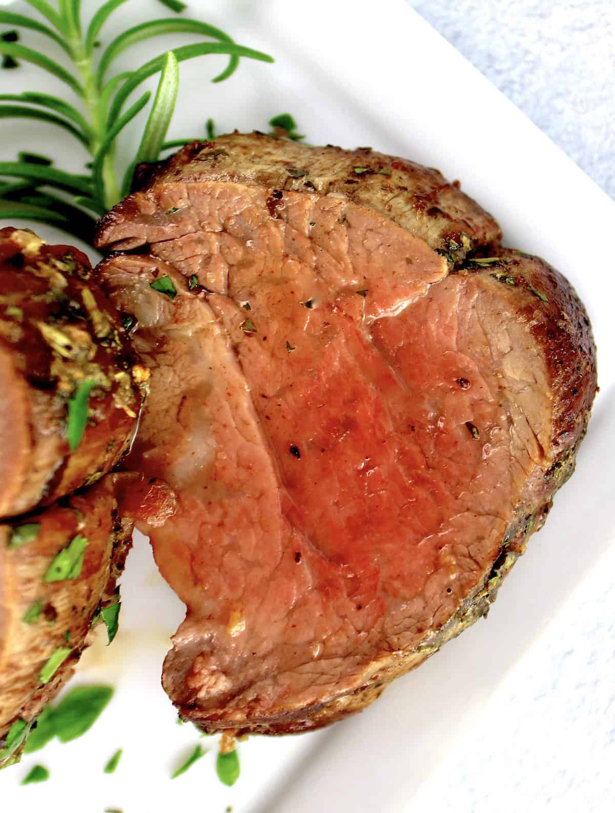 closeup of Roast Beef Tenderloin slice on white plate