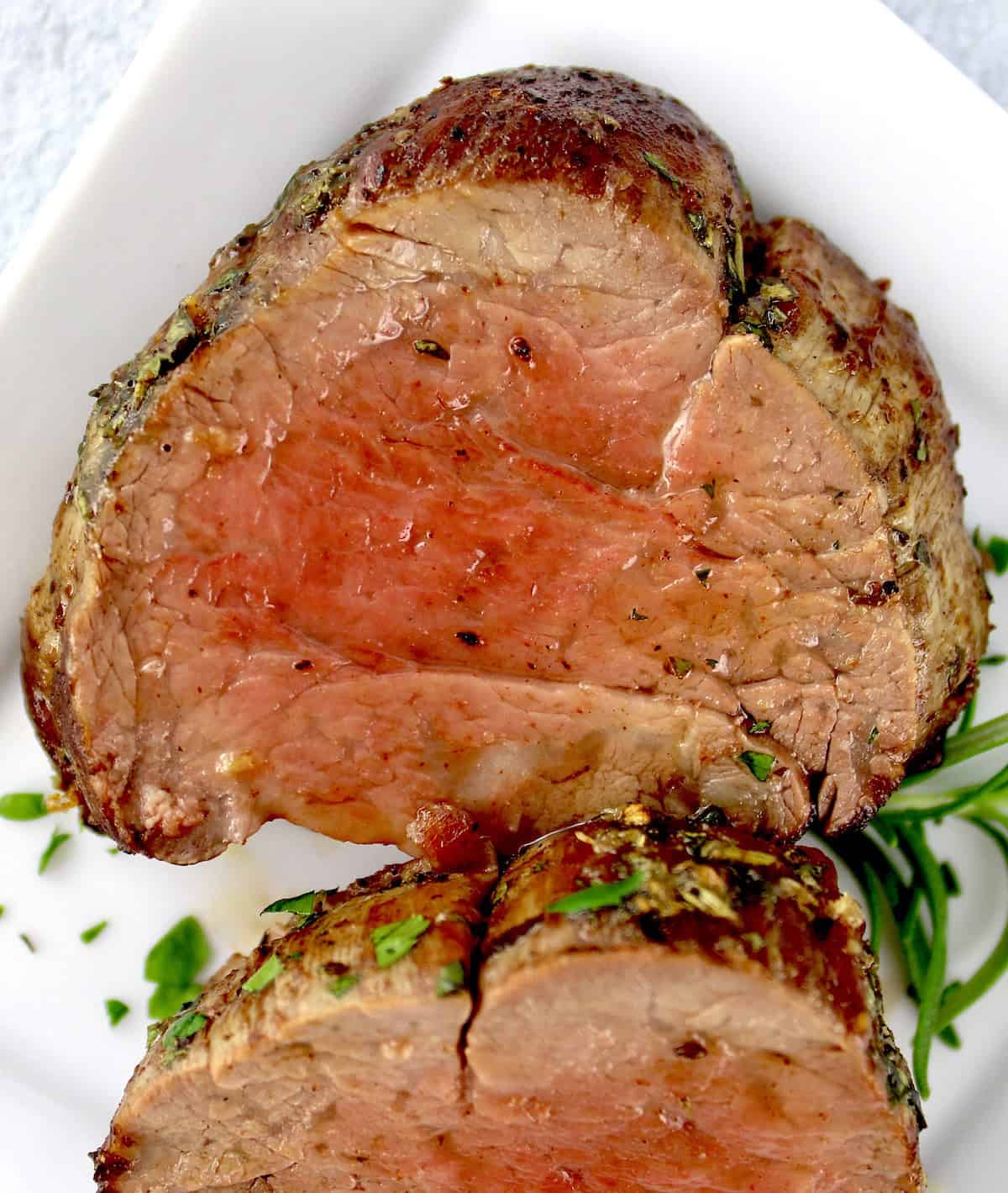 closeup of Roast Beef Tenderloin slice on white plate