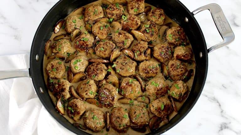 overhead view of Salisbury Steak Meatballs in black skillet with chopped parsley