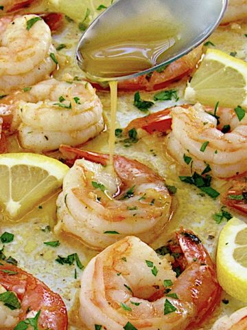 Sheet Pan Garlic Butter Shrimp with butter sauce being spooned over the top