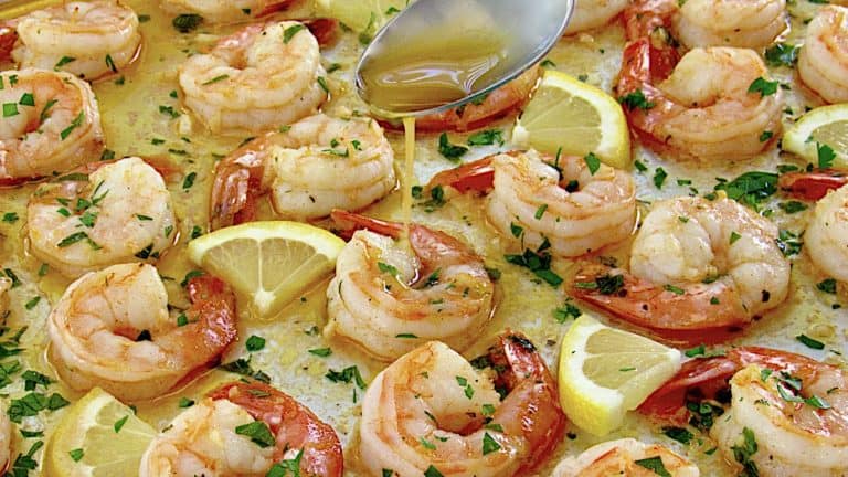 Sheet Pan Garlic Butter Shrimp with butter sauce being spooned over the top