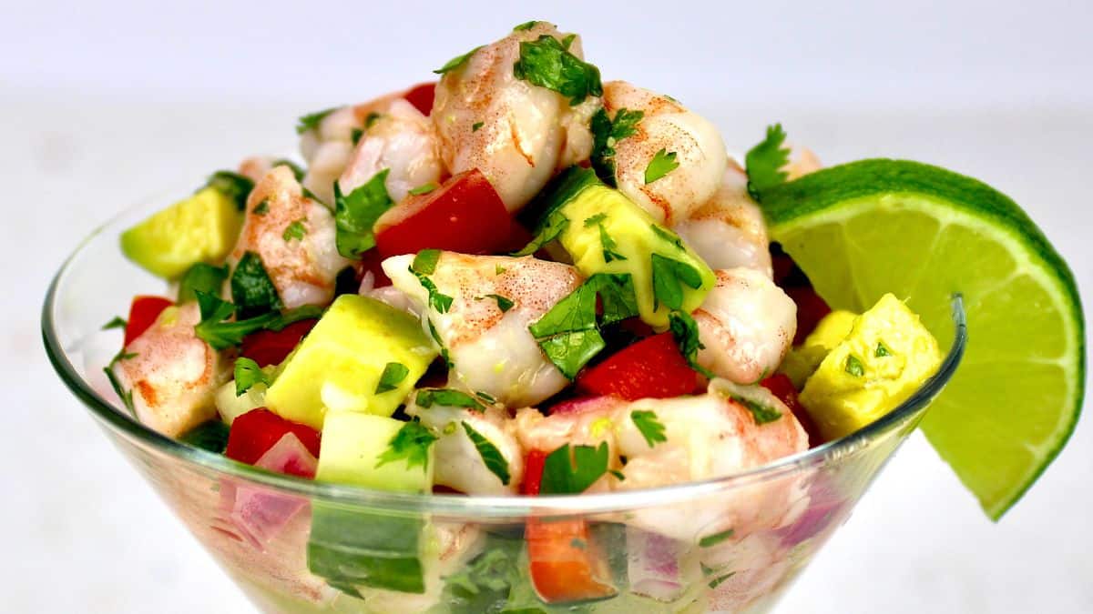 closeup of Shrimp Ceviche in martini glass with lime slice on right side