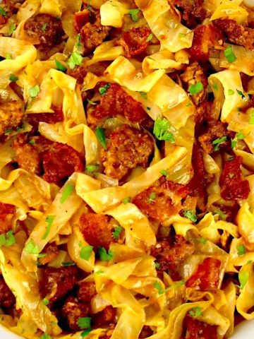 closeup of Slow Cooker Cabbage with sausage and bacon chunks