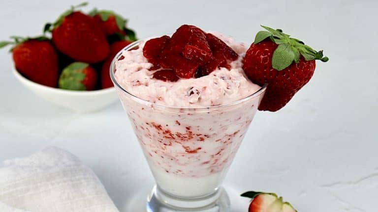 Strawberries and Cream in glass with strawberry and mint sprig on top