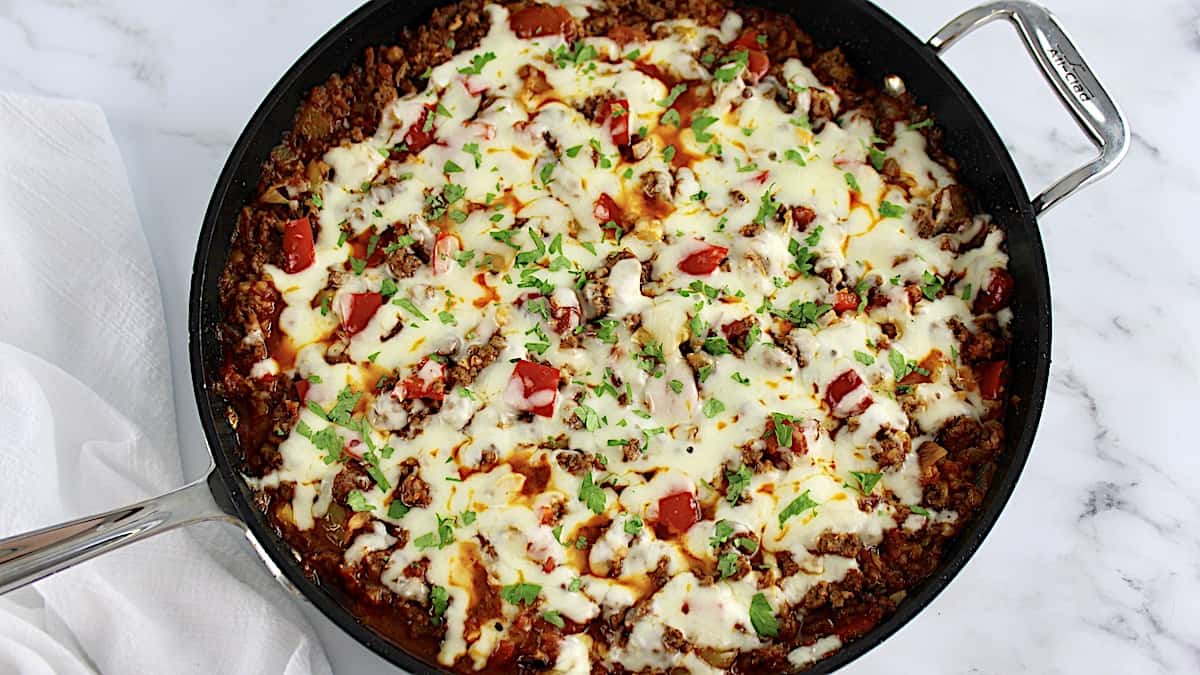 overhead view of Stuffed Pepper Skillet with melted cheese and chopped parsley over the top