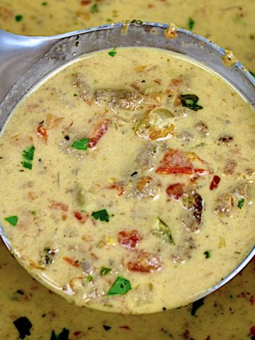 Taco Soup in ladle with chopped parsley