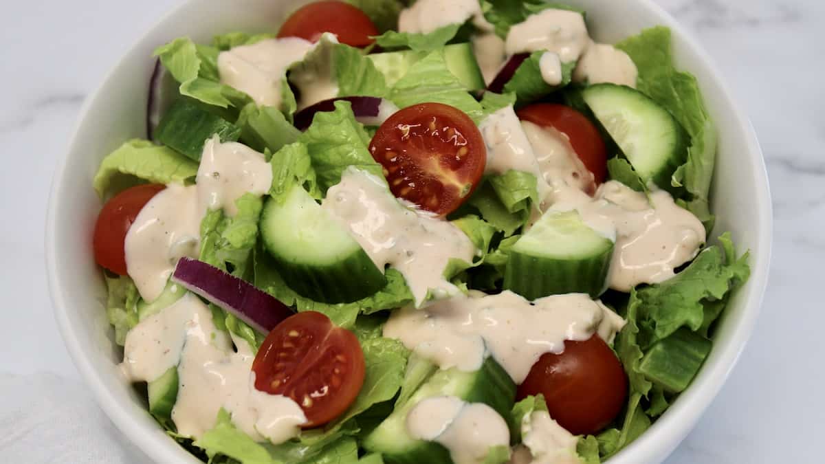 Thousand Island Dressing over salad in white bowl