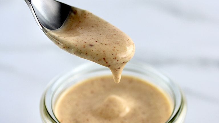 Yum Yum Sauce dripping off spoon into glass jar
