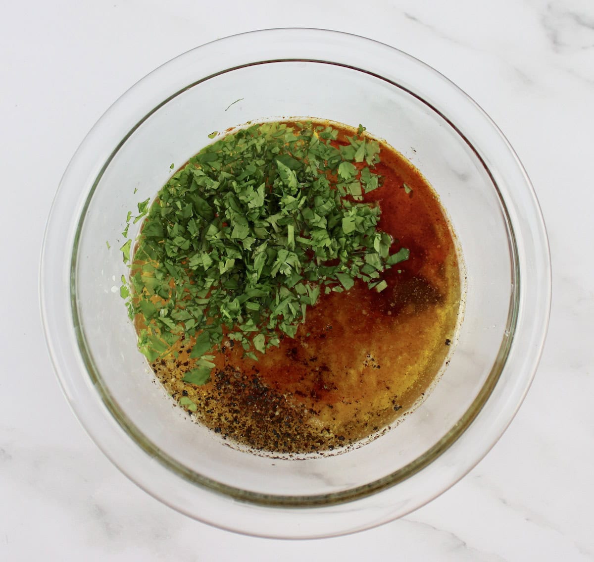 Carne Asada marinade ingredients in glass bowl unmixed