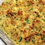 Cheddar Roasted Cauliflower in glass casserole with chopped parsley