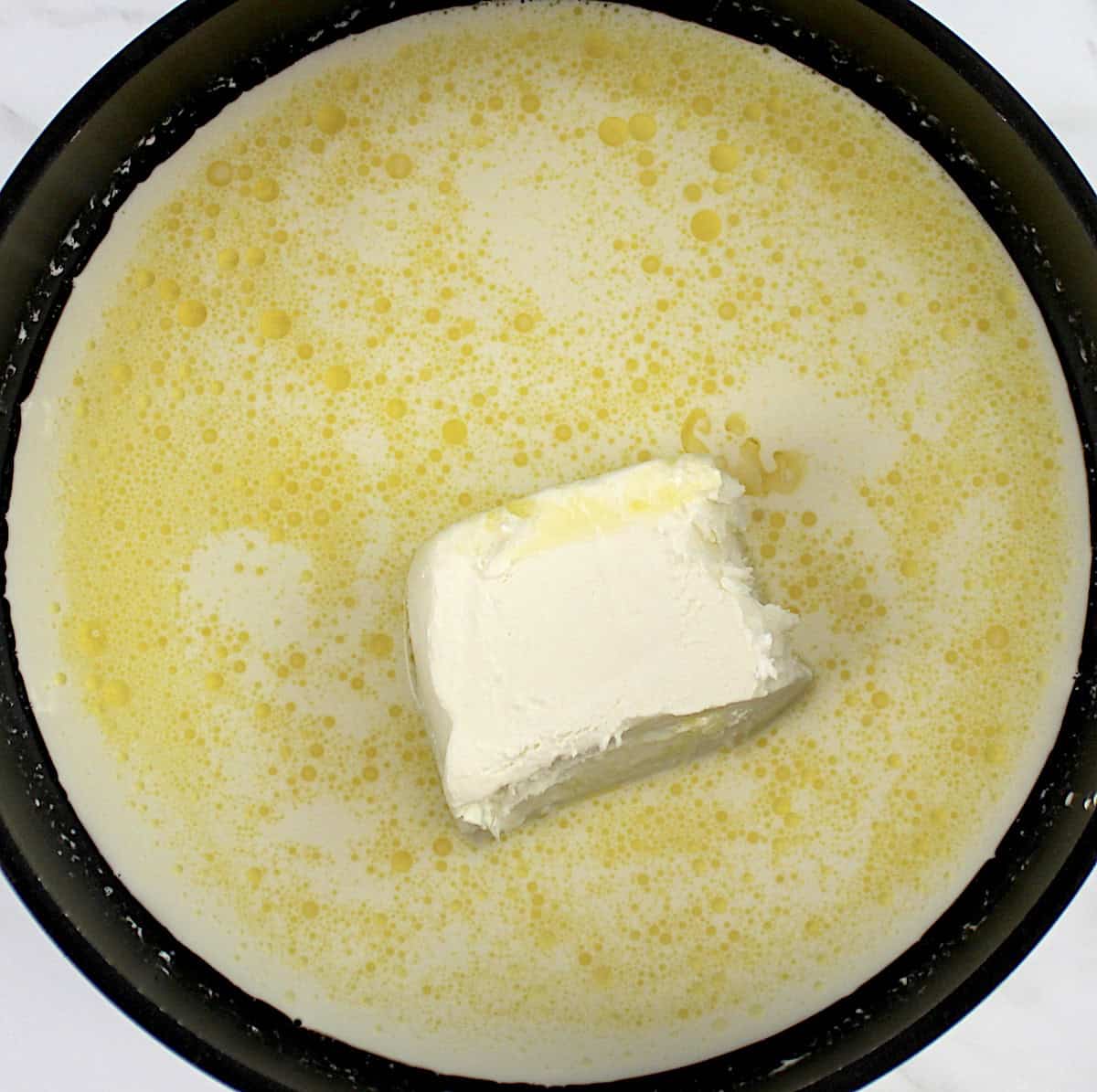 butter, cream and chunk of cream cheese in saucepan