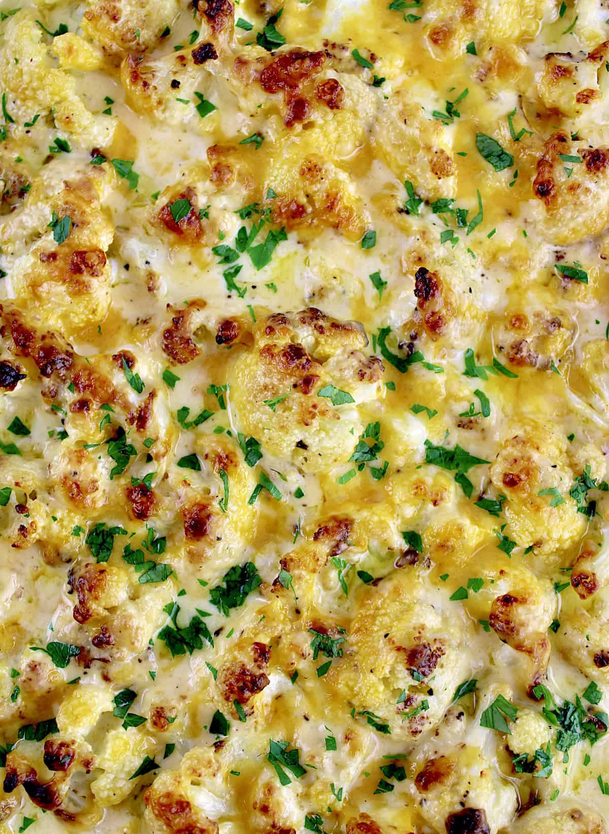 closeup of Cheddar Roasted Cauliflower with chopped parsley