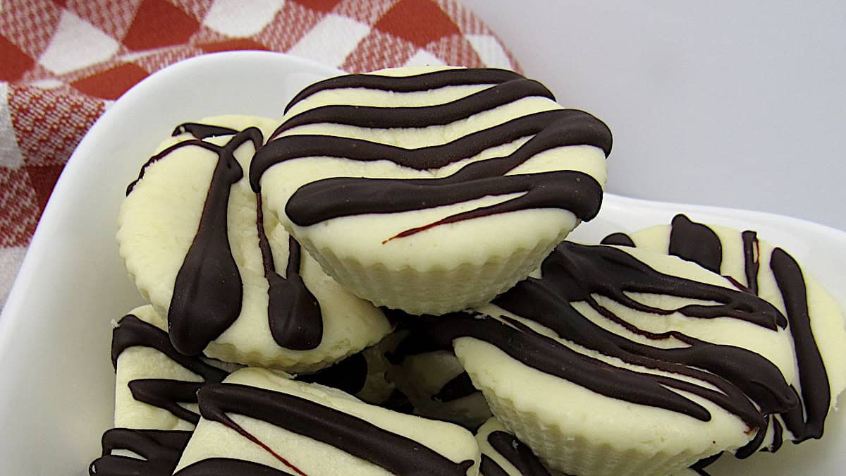 Cheesecake Fat Bombs drizzled with chocolate piled up