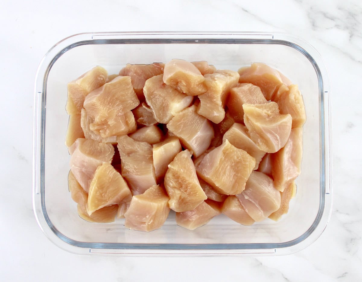 chunks of chicken breast in glass storage container