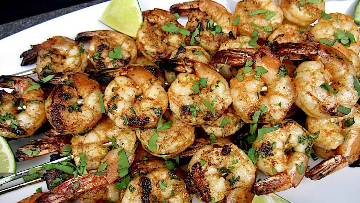 lime cilantro shrimp skewers with lime wedge in back