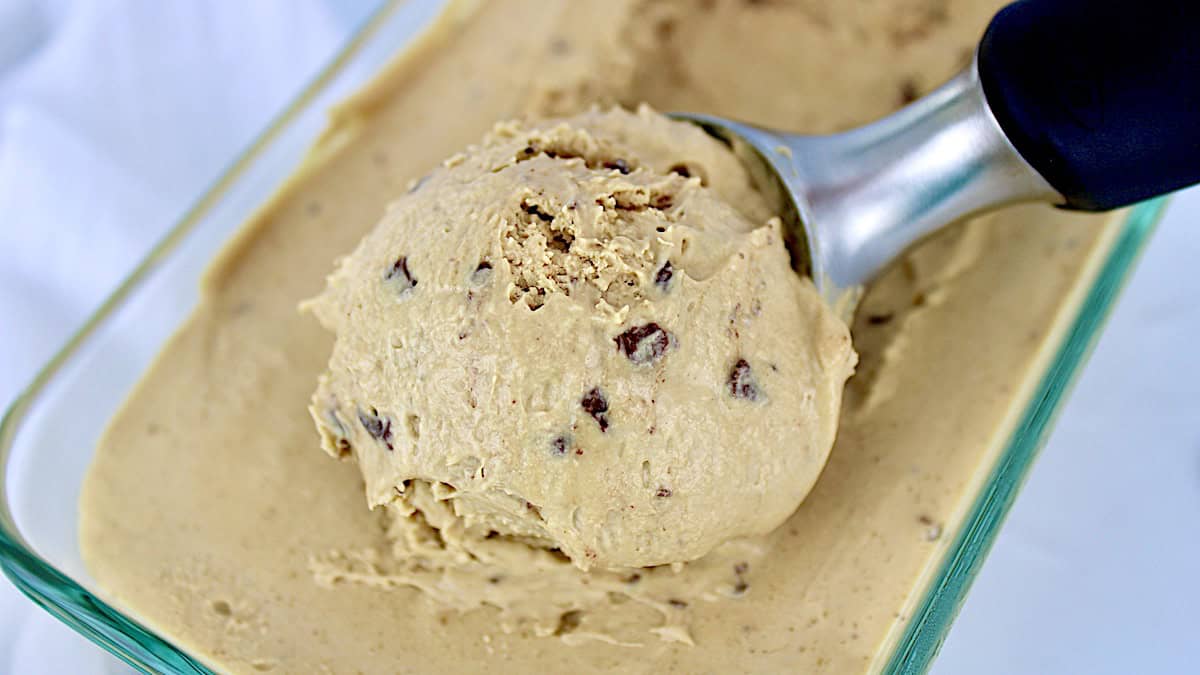 Keto Coffee Chip Ice Cream being scooped out of glass container