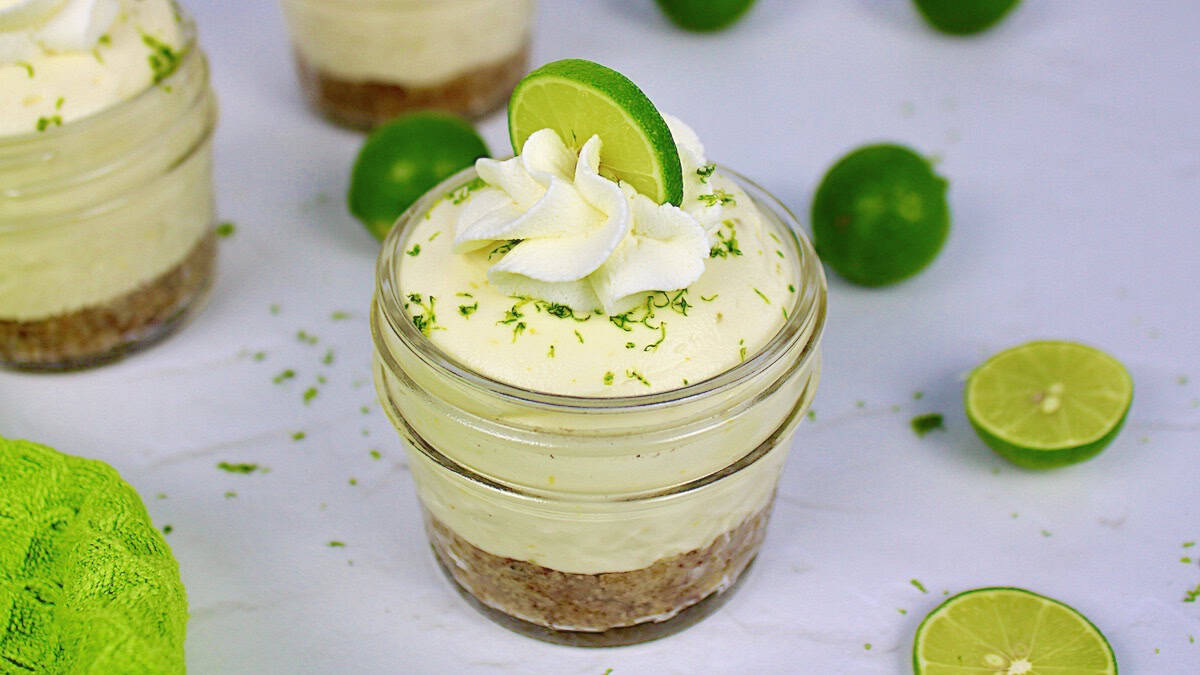 Keto No Bake Key Lime Cheesecake in glass jar with whip cream and lime on top