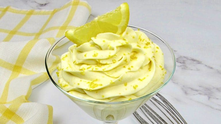 Lemon Cheesecake Mousse in glass with lemon zest and lemon slice on top