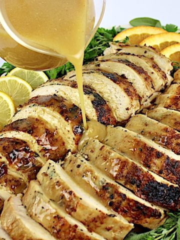 Slow Cooker Turkey Breast sliced on platter with gravy being poured over