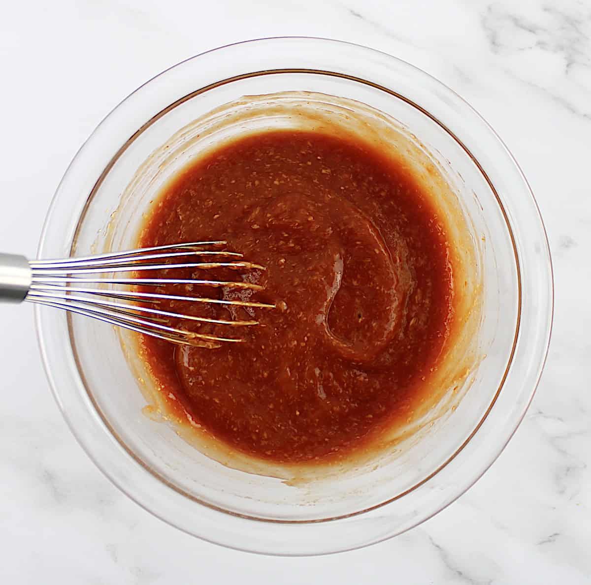 cocktail sauce in glass bowl with whisk