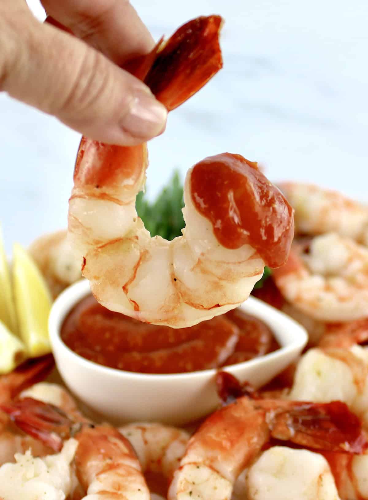 Shrimp dipped in cocktail sauce