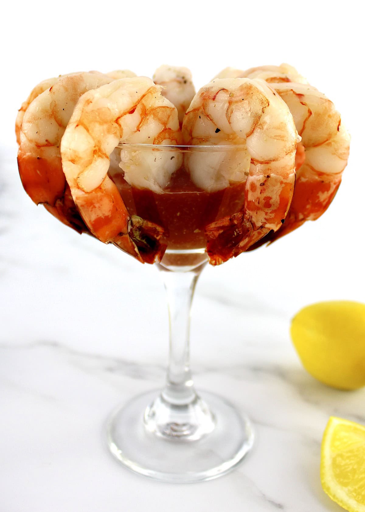 Shrimp Cocktail in martini glass with lemon on side