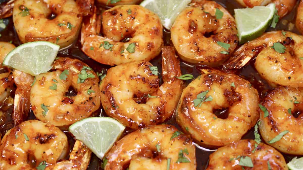 closeup of Chili Lime Shrimp with lime wedges