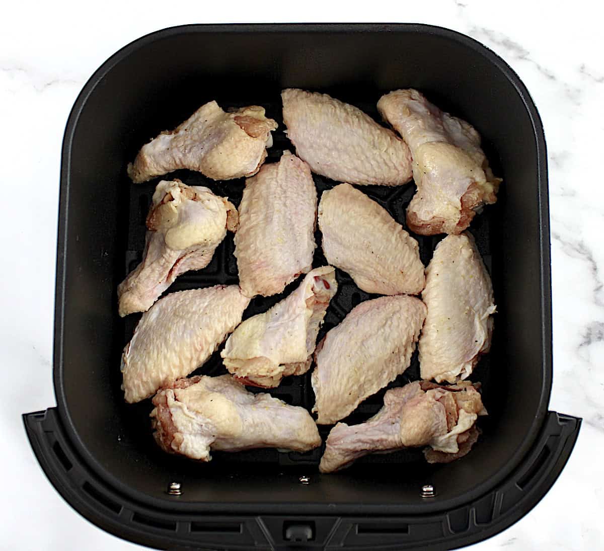 12 raw chicken wings in air fryer basket
