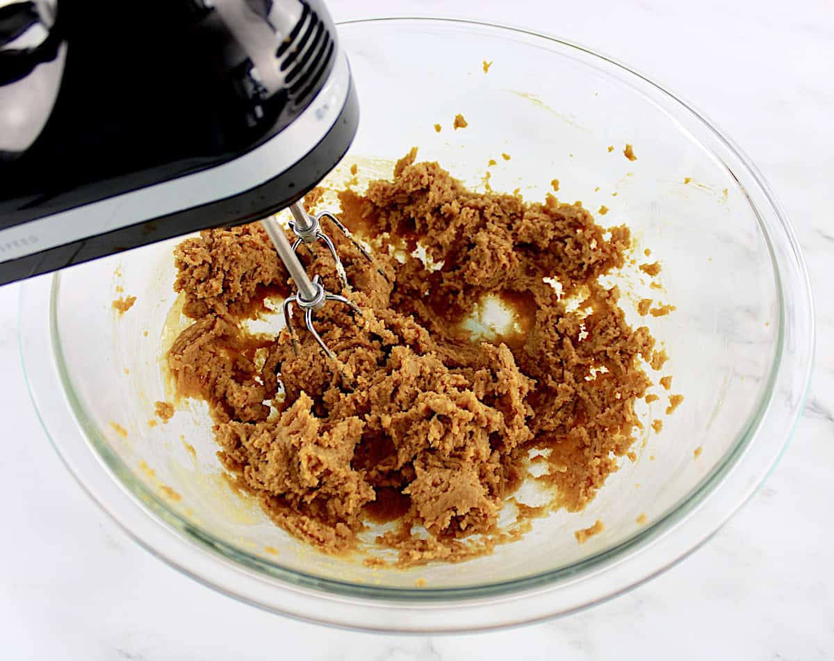 Easy Peanut Butter Cookies dough in glass bowl being mixed with hand mixer
