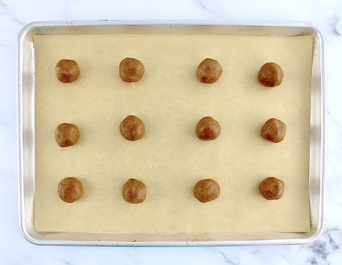 12 Easy Peanut Butter Cookies dough balls on baking sheet with parchment paper