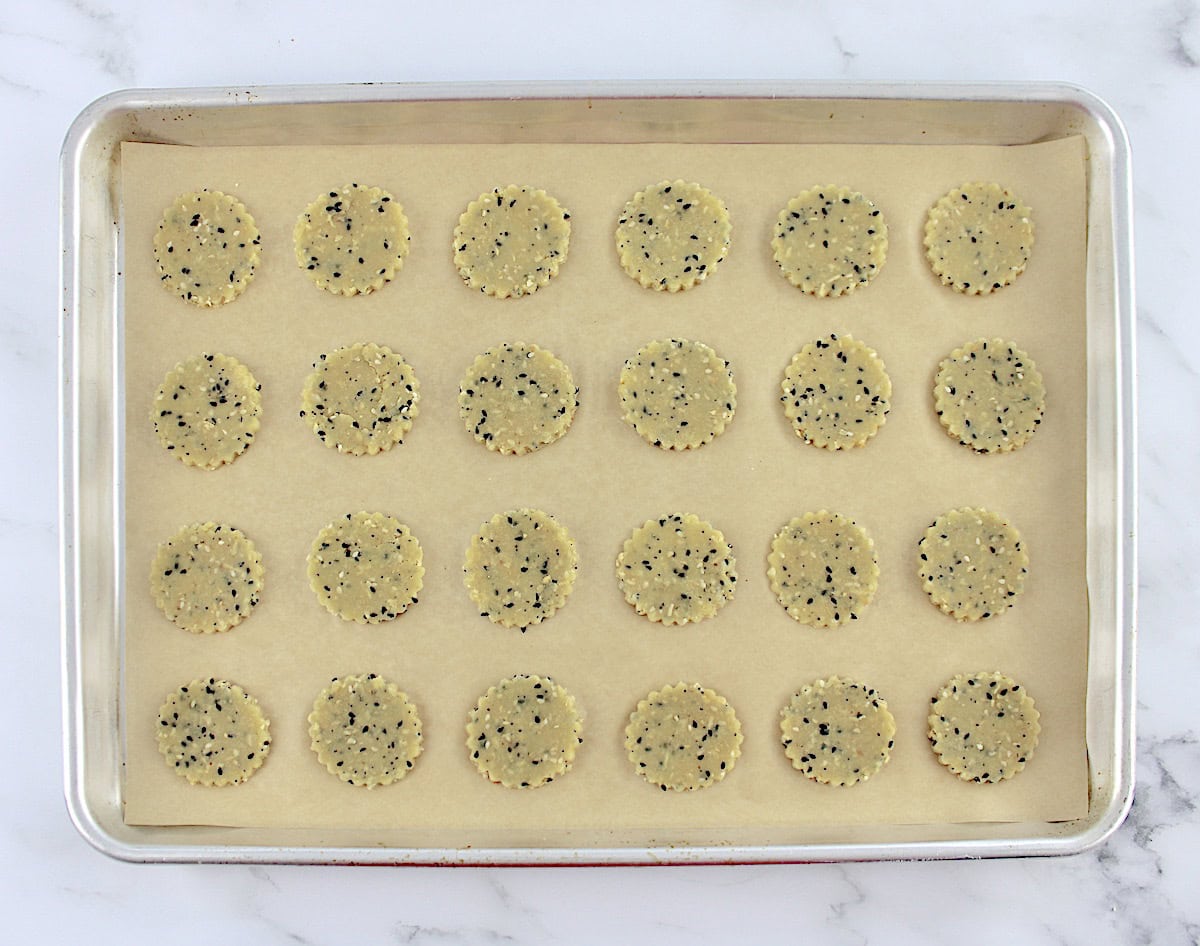 Everything Bagel Crackers dough unbaked on baking sheet with parchment paper