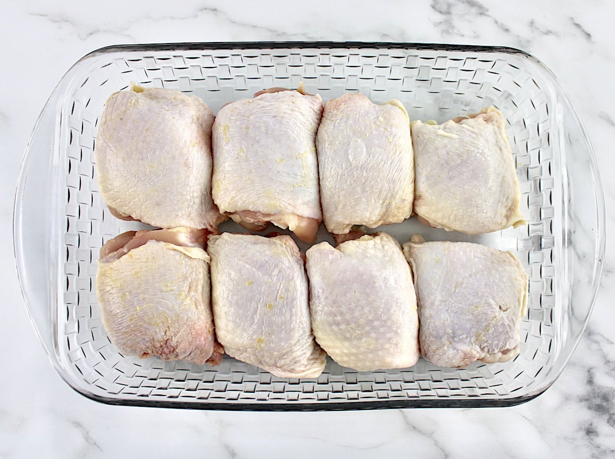 8 chicken thighs in a glass baking dish