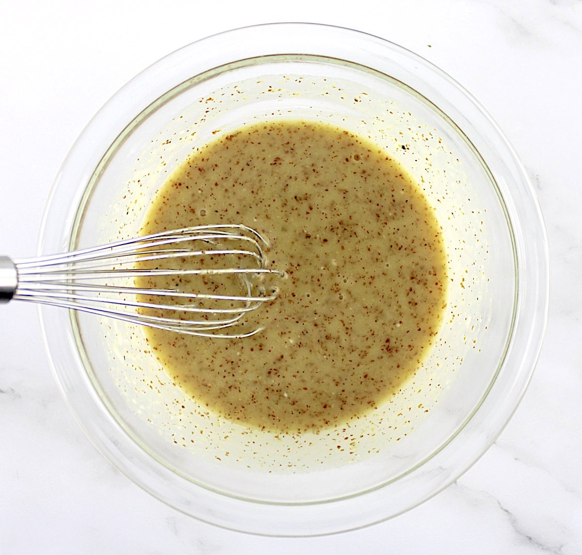 honey mustard sauce in glass bowl with whisk