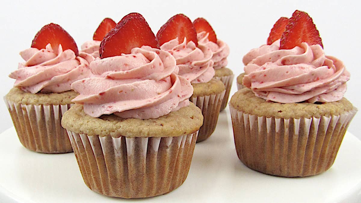 closeup of strawberry cupcakes with sliced strawberry on top