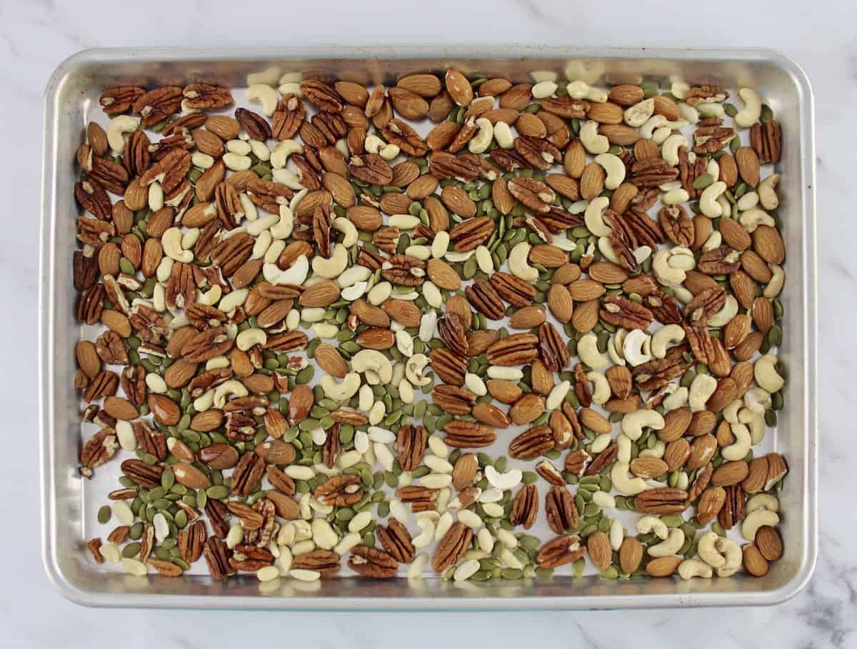 raw mixed nuts on baking sheet 