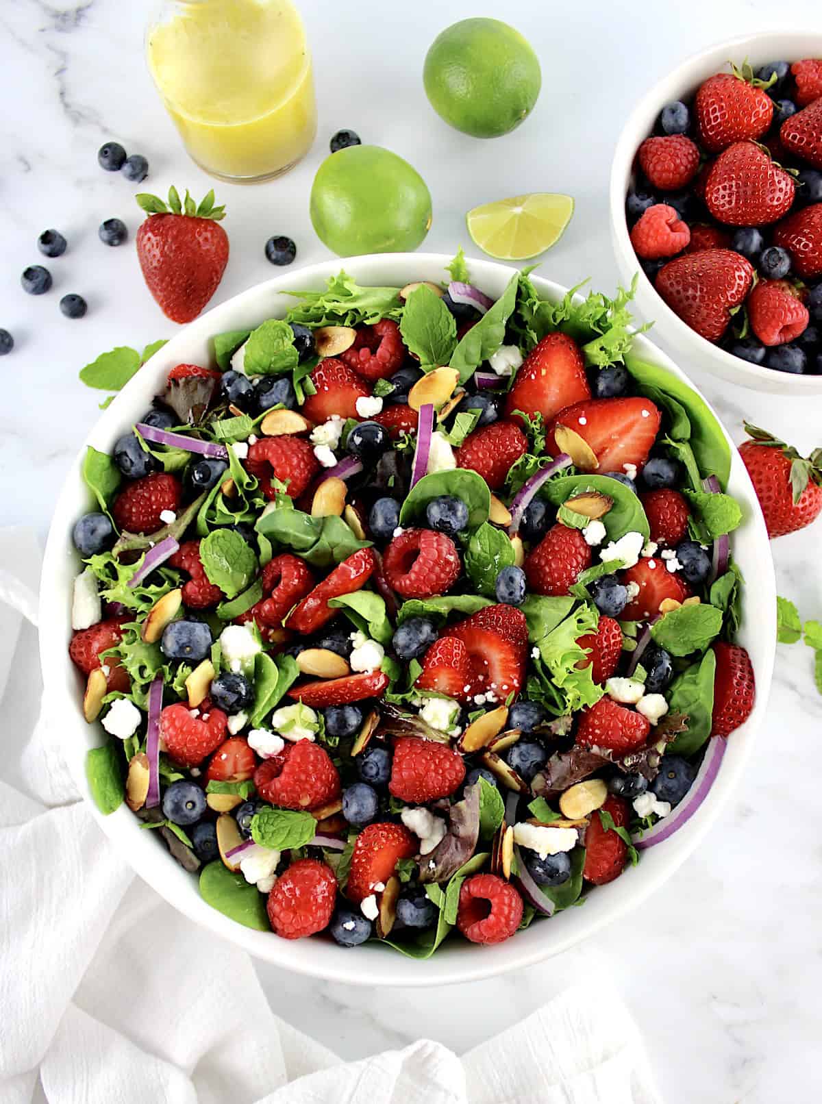 overhead view of Triple Berry Salad with berries and dressing in back