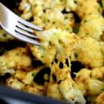 Air Fryer Cheesy Cauliflower with fork pulled piece with cheese