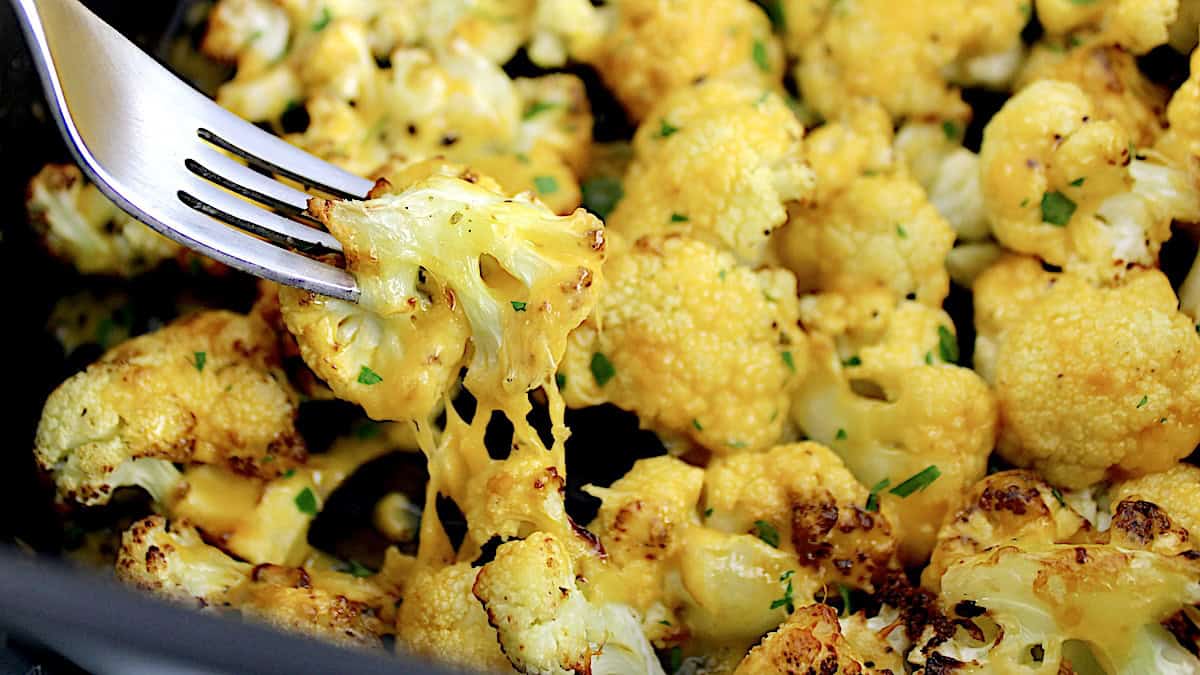 Air Fryer Cheesy Cauliflower with fork pulling piece up