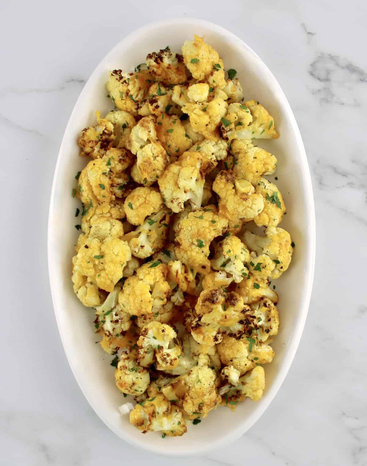 overhead view of Air Fryer Cheesy Cauliflower on white oval platter