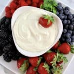 Easy Fruit Dip in white bowl with berries all around the sides