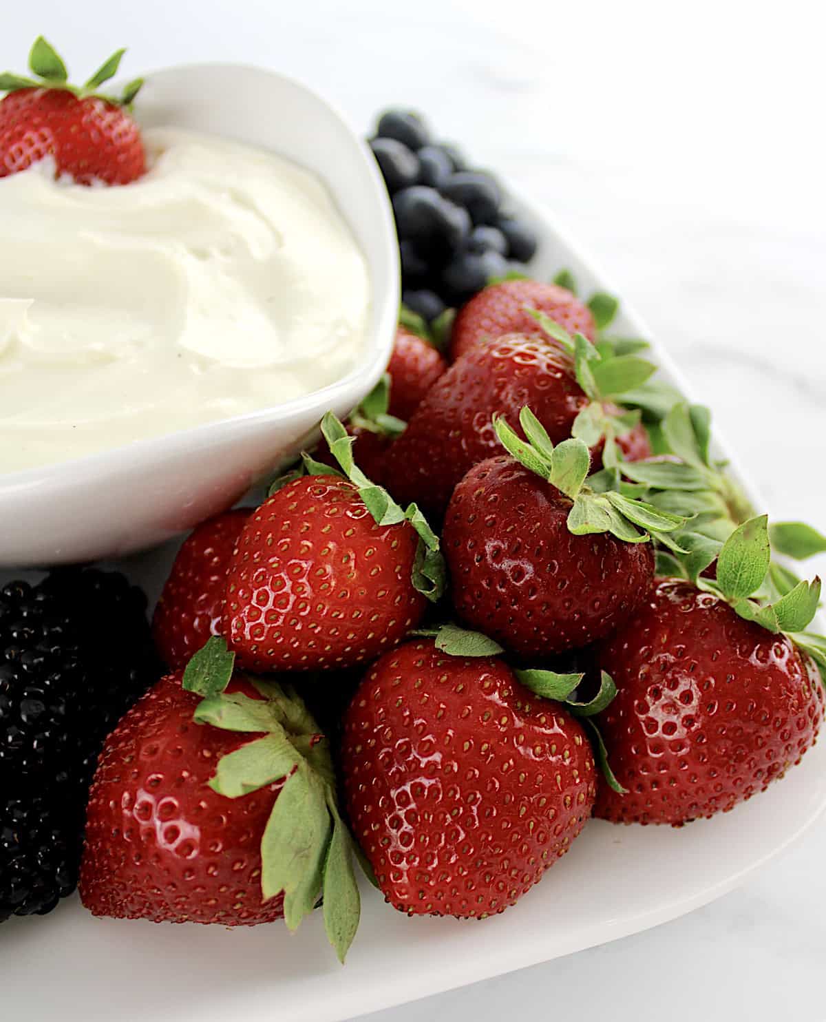 Easy Fruit Dip in white bowl with fresh strawberries on side