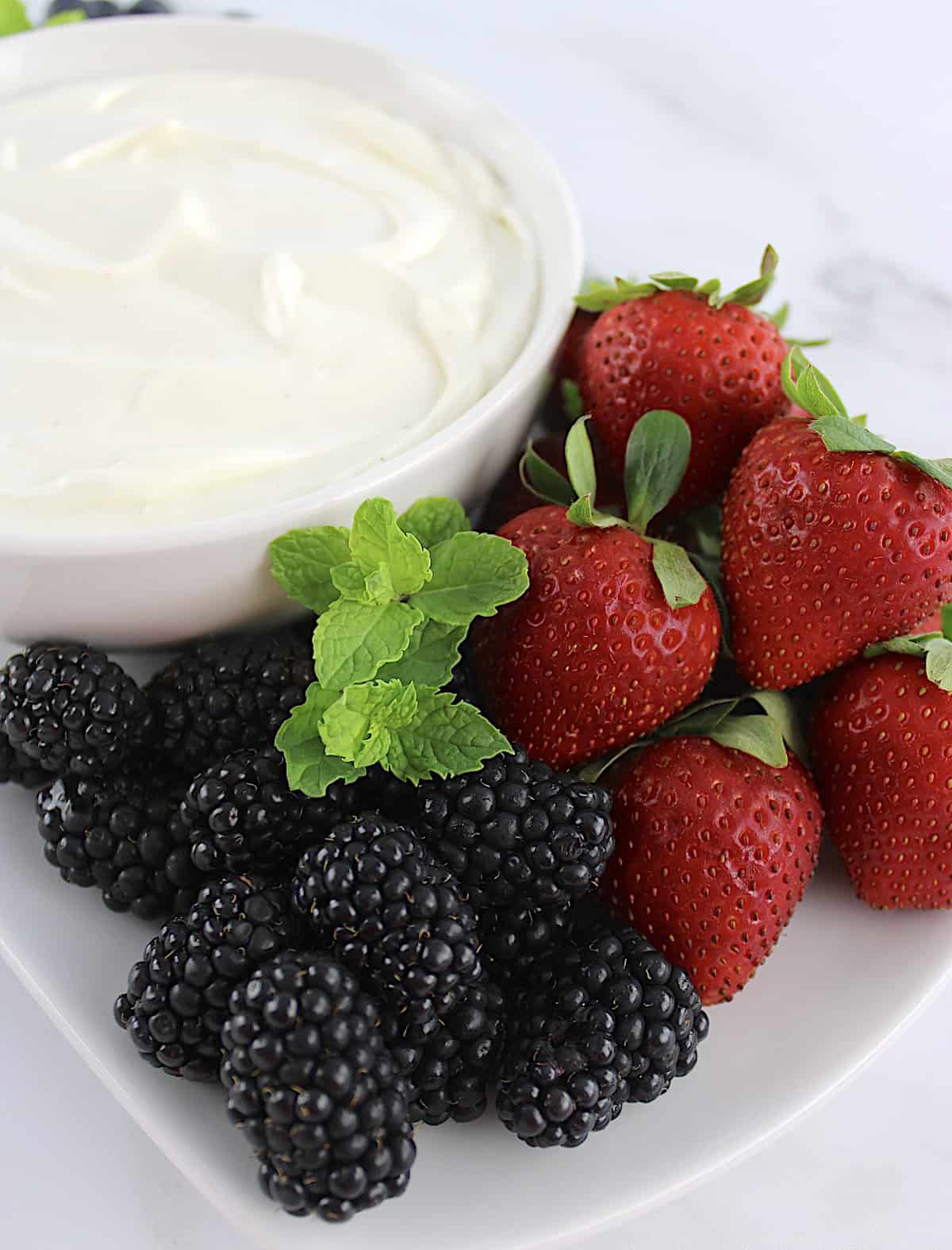 Easy Fruit Dip in white bowl with fresh strawberries and blackberries on side